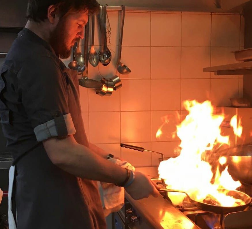 Niko working the pass over an open flame